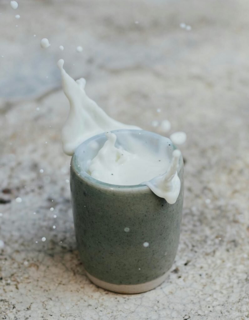 Milk product in rustic clay jug on stone tabletop