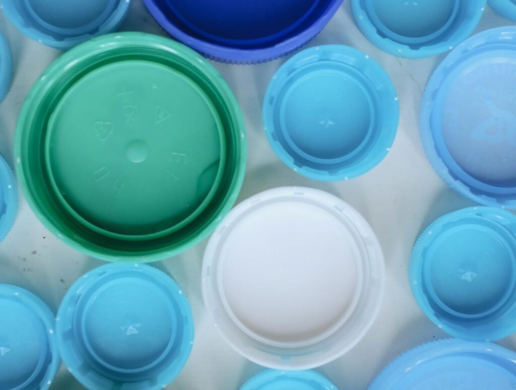 Aerial view of assorted colorful plastic bottle caps highlighting recycling and sustainability.