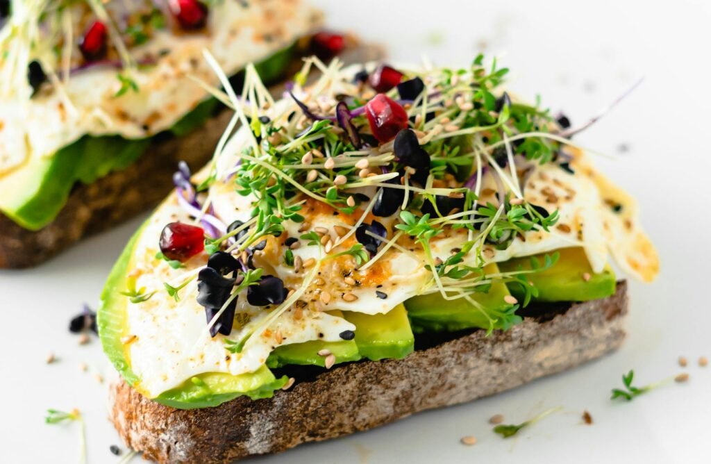 Delicious and nutritious avocado toast topped with sprouts and seeds, perfect for a healthy breakfast.