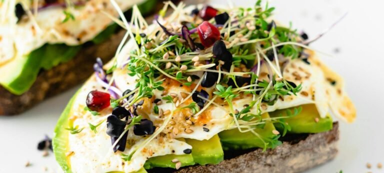 Delicious and nutritious avocado toast topped with sprouts and seeds, perfect for a healthy breakfast.