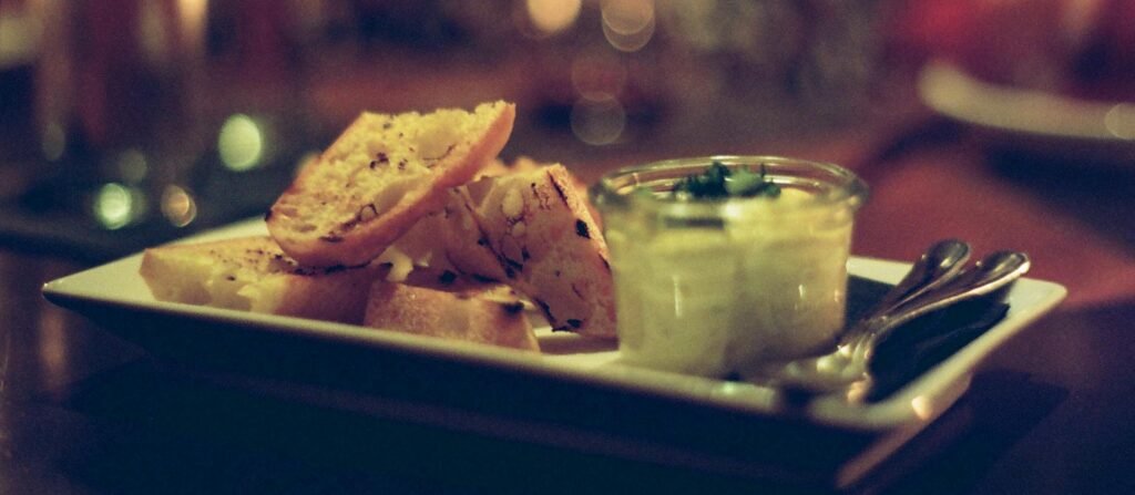 A cozy scene of bruschetta served with creamy dip in a restaurant setting.